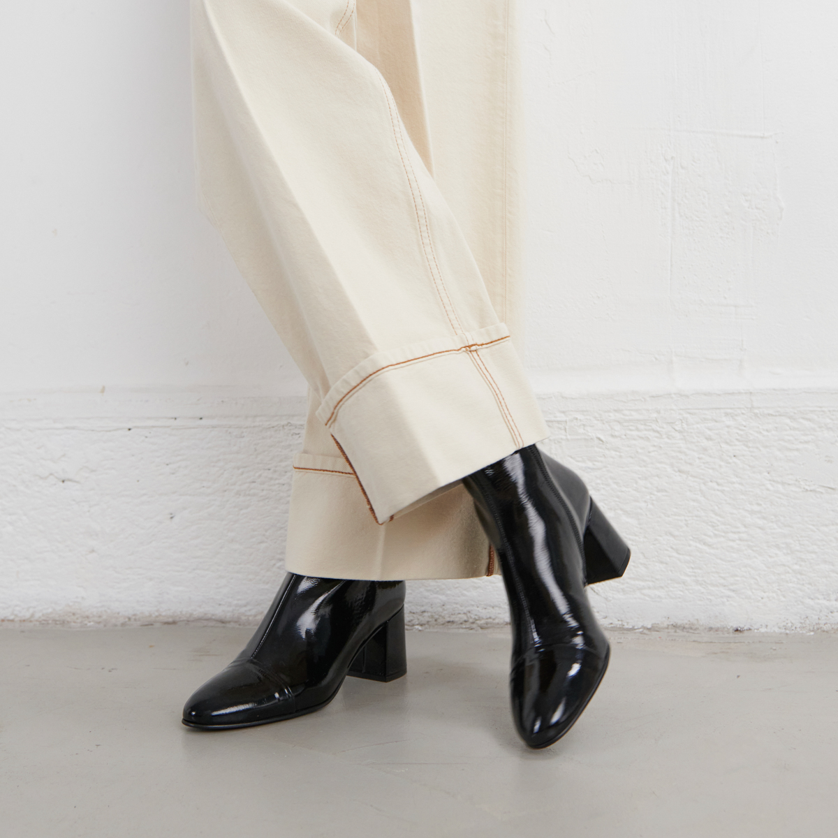 Heeled boots in black pleated patent | DONIAMA