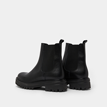 Boots with notched and elastic soles in black leather | amandine