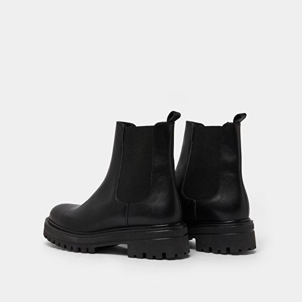 Boots with notched and elastic soles in black leather | AMANDINE