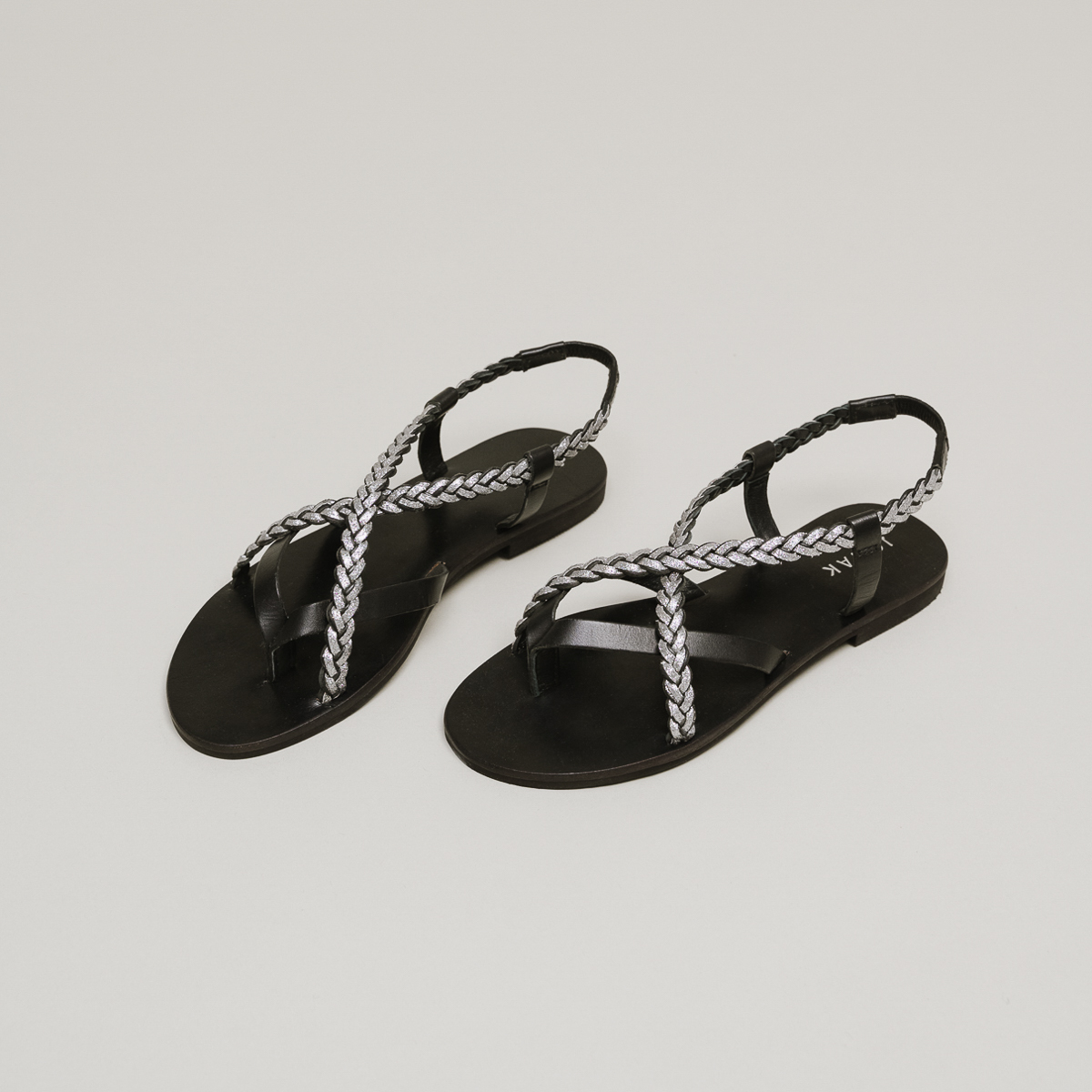Sandals with braided straps in black and silver leather | WARREN