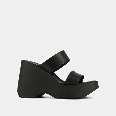 Wedge mules with straps in black leather | priscilla
