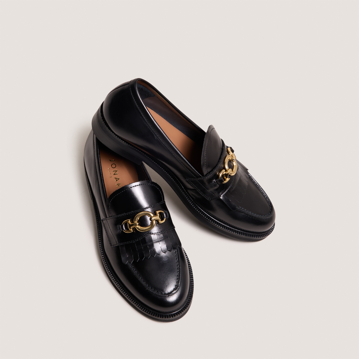Loafers with gold buckles in black leather | DELPHES