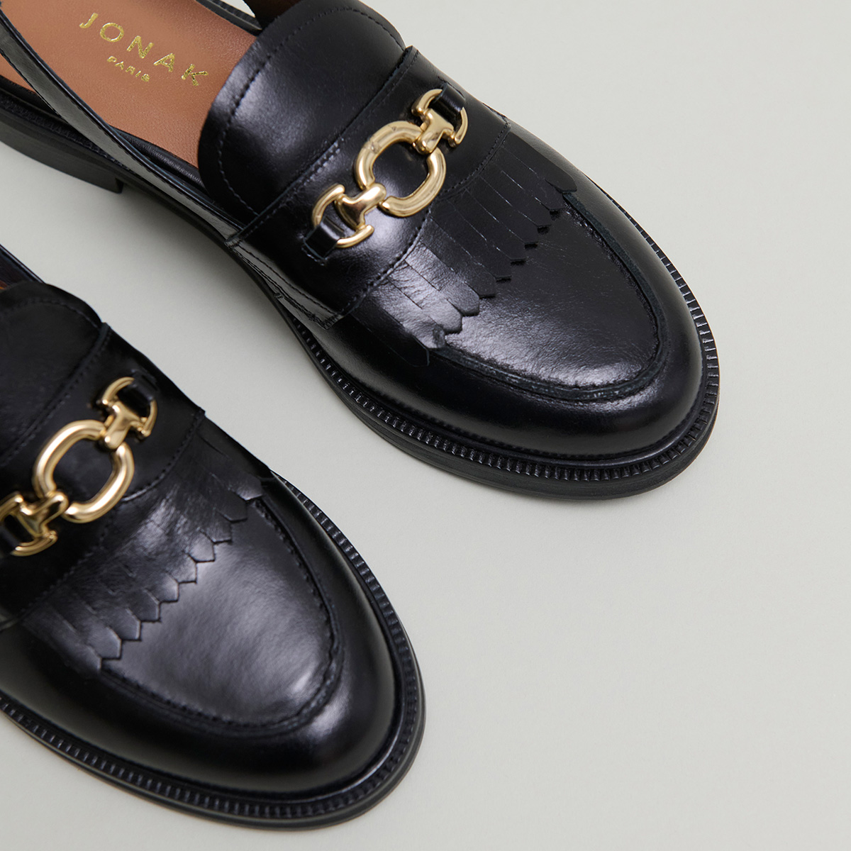 Loafers with open backs in black leather | DELPHY
