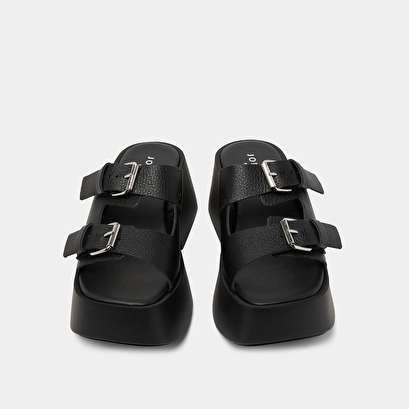 Mules with thick straps, buckles and open toes in black grained leather | ENOLA