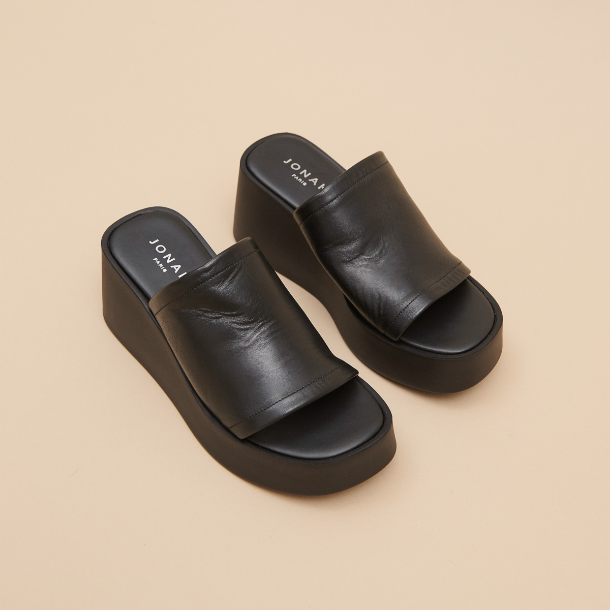 Wedge mules in black leather | EUGENE
