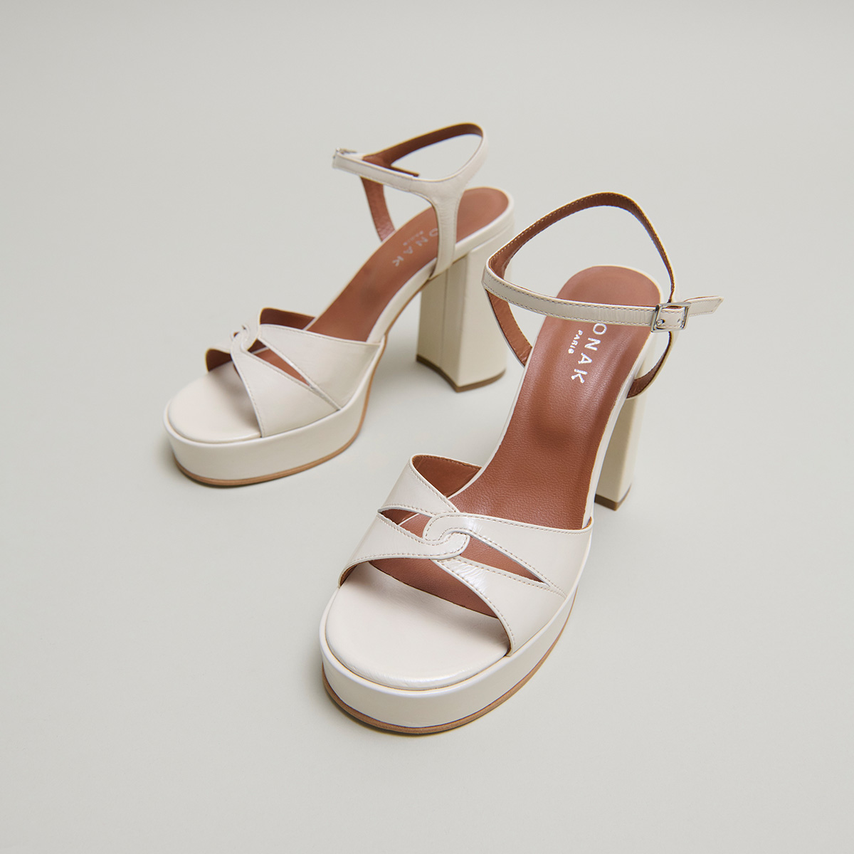 Platform sandals and high heels in ecru shiny leather | JUSTINE