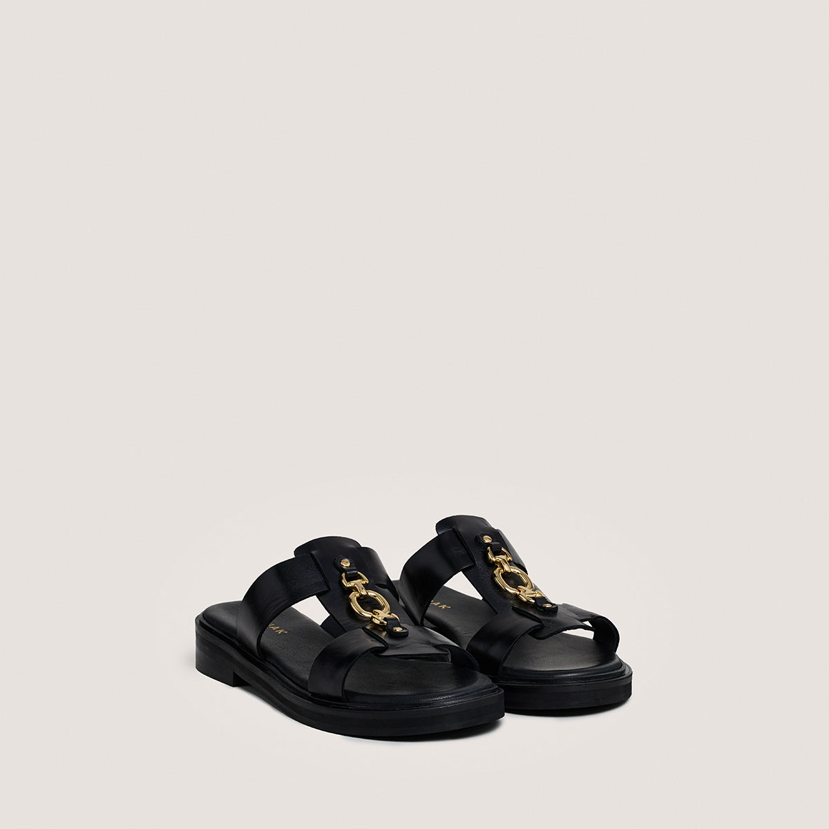 Mules with golden jaws in black leather | DOP