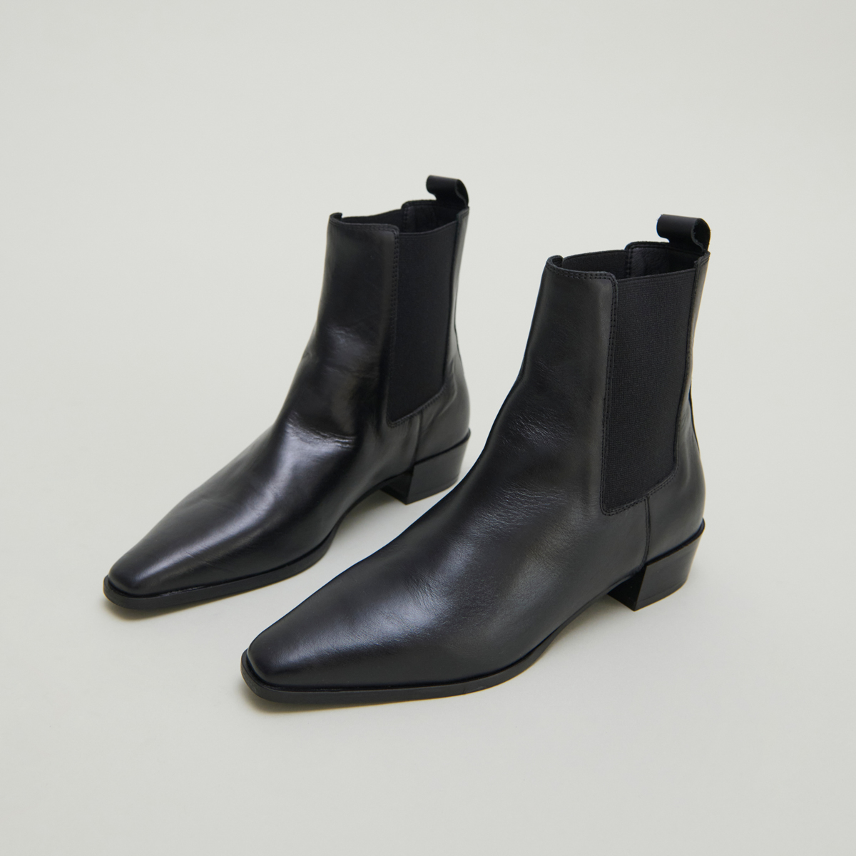 Boots with slight beveled heels and pointed toes in black leather | PAPAYE