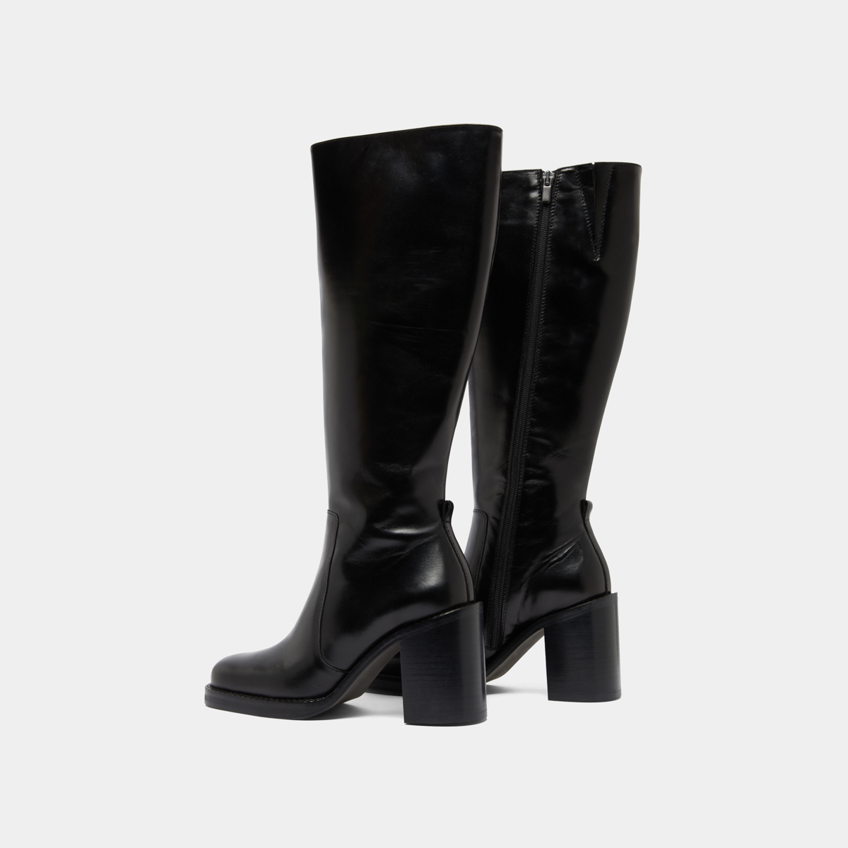 Boots with overflowing heels in black leather | BRETZEL