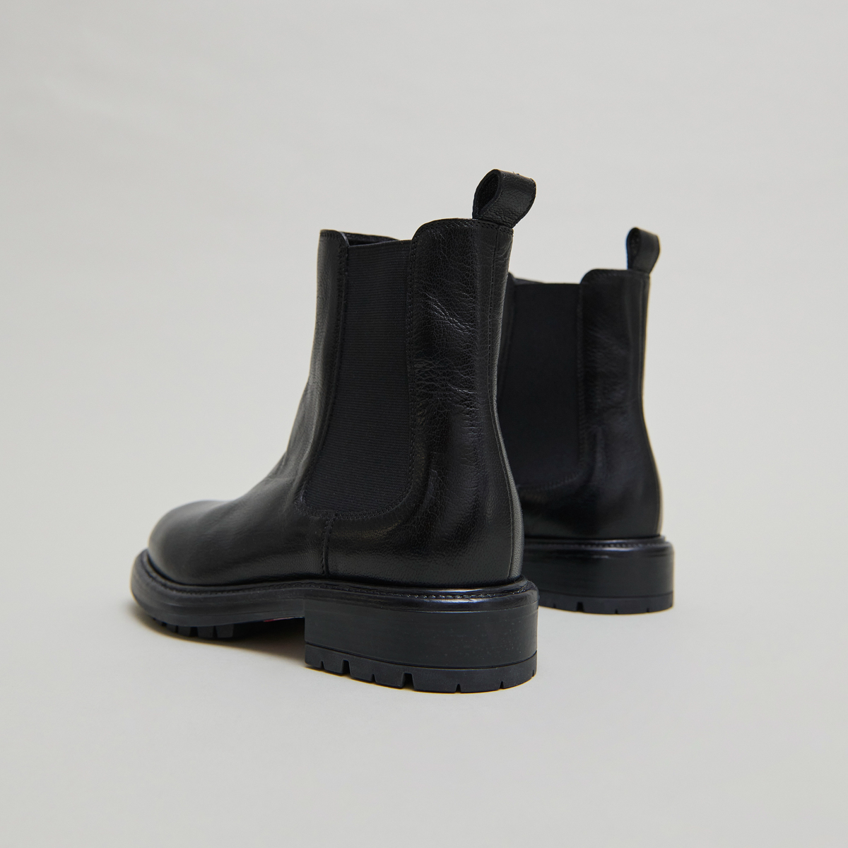 Lowboots with elastic straps and notched soles in black grained leather | CELINA