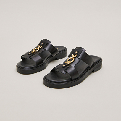 Mules with golden jaws in black leather | dop