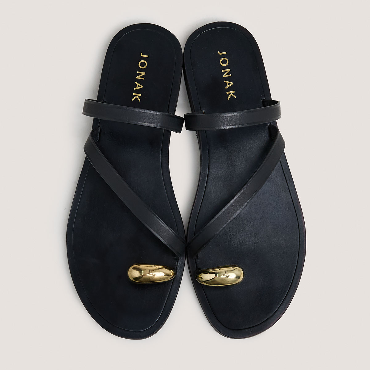Sandals with slender straps and gold details in black leather | WIFE