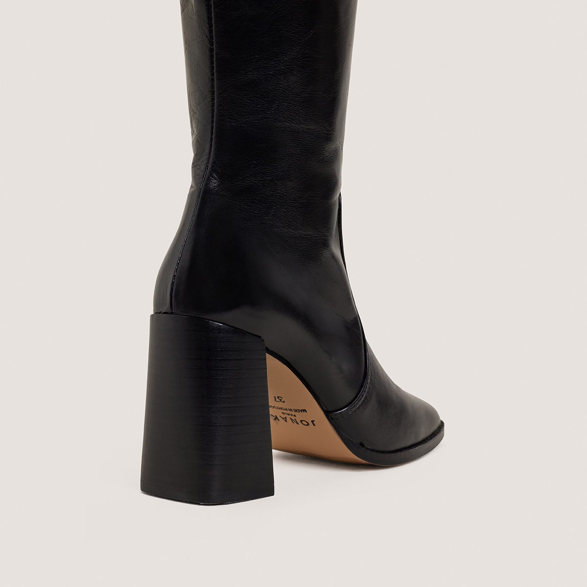 High-heeled boots in aged black leather | VAUBY