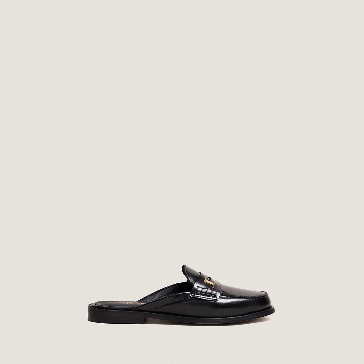Backless loafers with monogram detailing in black patent leather | AMAURY