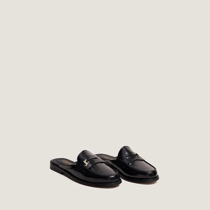 Backless loafers with monogram detailing in black patent leather | amaury