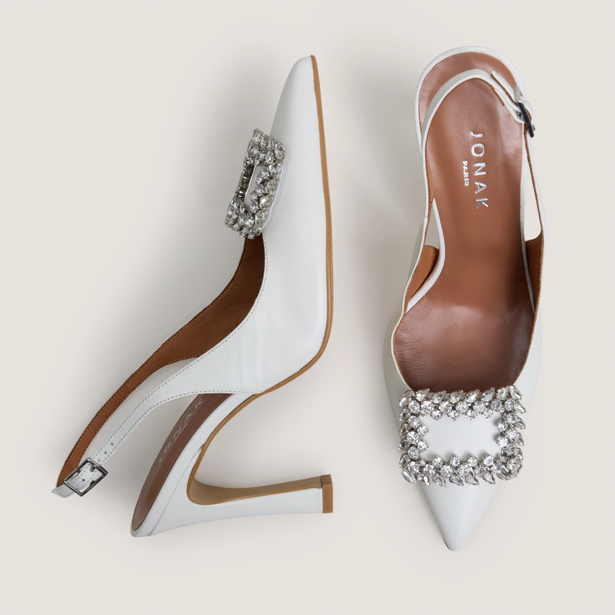 Slingback Slingback pumps embellished with rhinestones in ecru leather | DOVELA