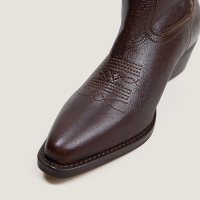 Pointed-toe boots with visible stitching brown