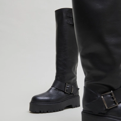 Chunky strap boots with treaded soles in black grained leather | reine